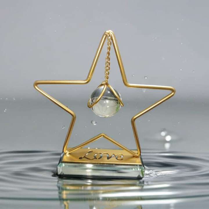 Gold star-shaped trophy with a crystal ball on a reflective surface