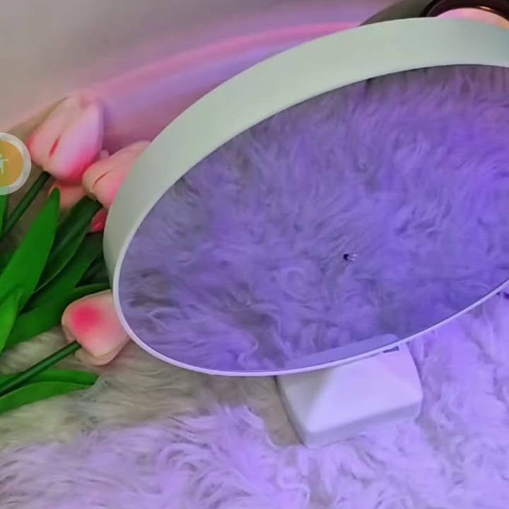 Round white object with purple light on a fluffy surface