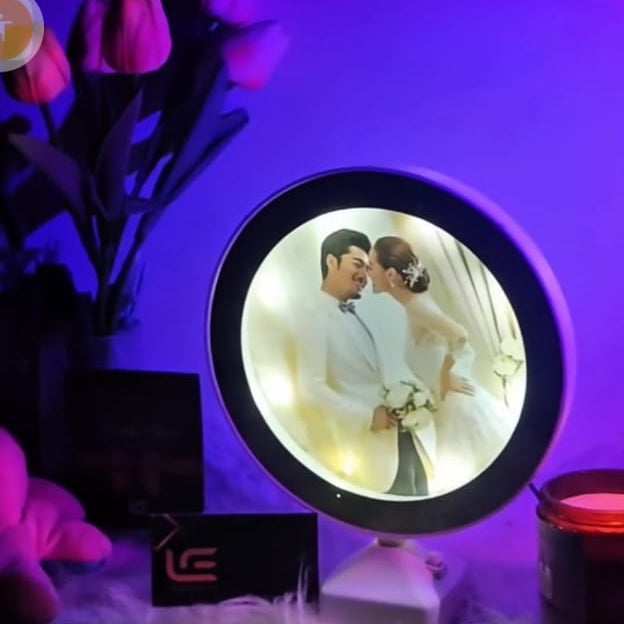 Phone screen showing a photo of a couple with a purple circular light effect.