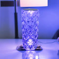 Blue glass lamp on a table with a blurred background