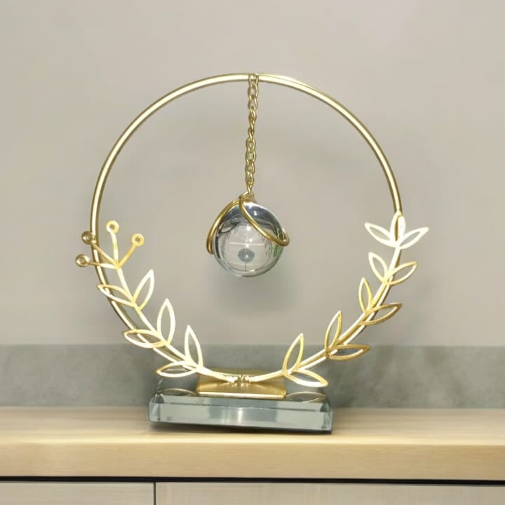 Decorative clock with gold wreath on a neutral background